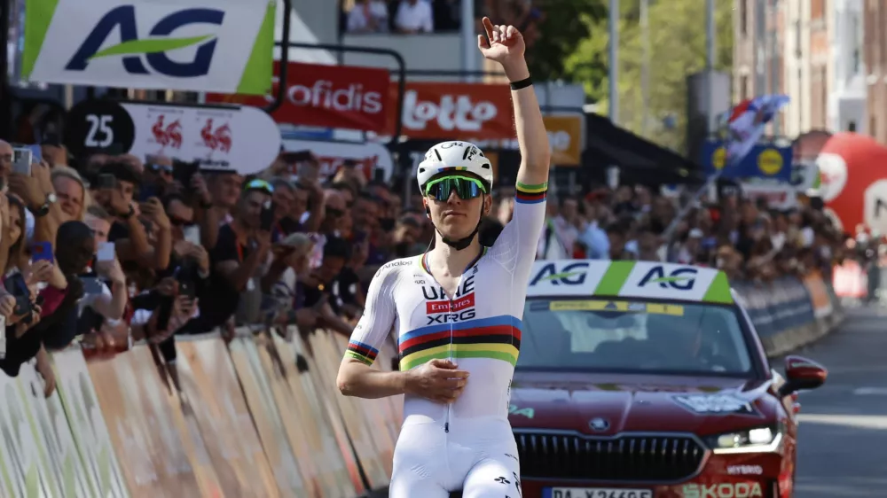 Slovenia's Tadej Pogacar of the UAE Team Emirates URG team crosses the finish line to win the Belgian cycling classic and UCI World Tour race Liege Bastogne Liege, in Liege, Belgium, Sunday, April 27, 2025. (AP Photo/Geert Vanden Wijngaert)