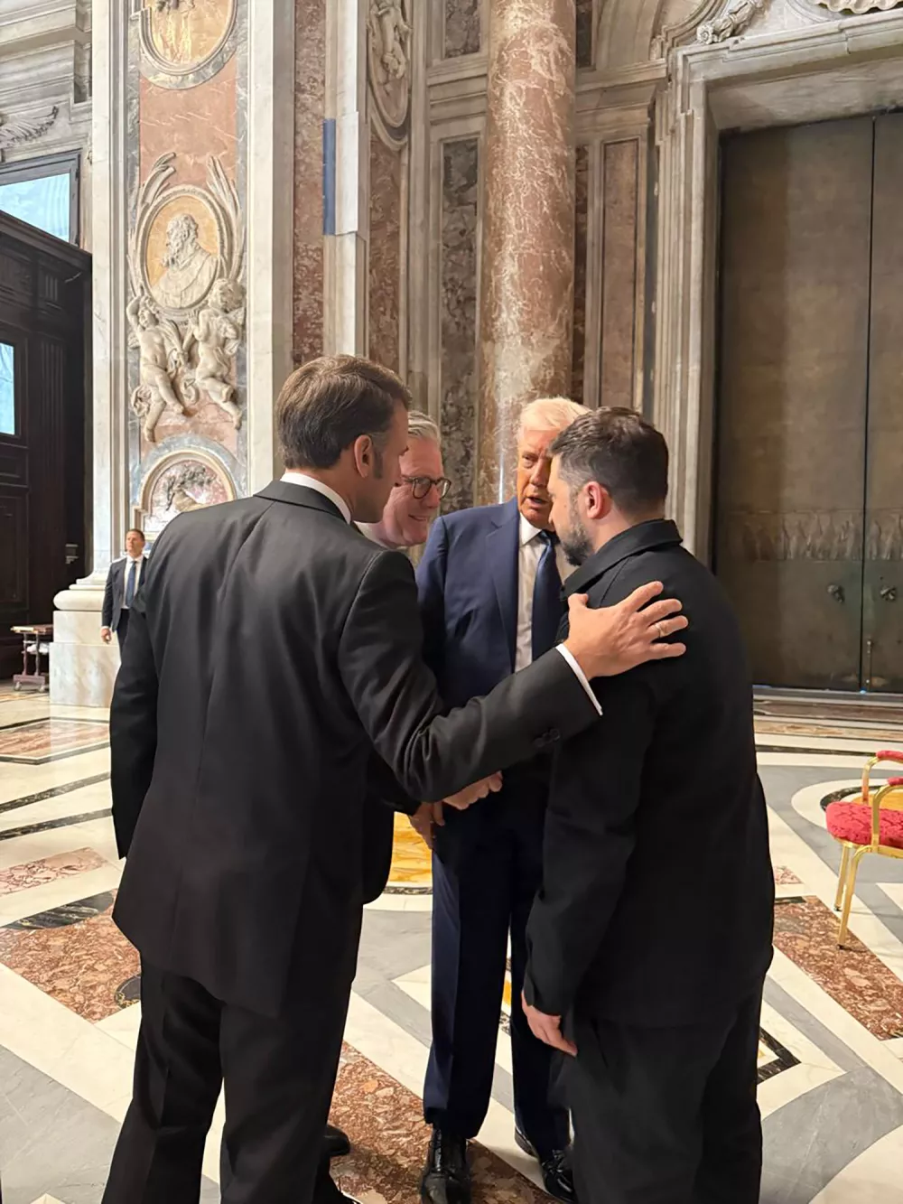 In this photo provided by the Ukrainian Presidential Press Office, Ukraine's President Volodymyr Zelenskyy, right, President Donald Trump, second right, French President Emmanuel Macron, left, and British Prime Minister Keir Starmer talk as they attend the funeral of Pope Francis in Vatican, Saturday, April 26, 2025.(Ukrainian Presidential Press Office via AP)