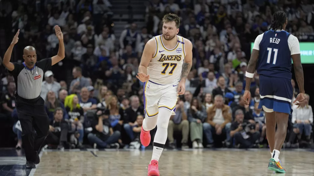 Los Angeles Lakers guard Luka Doncic (77) gestures after making a 3-point basket during the first half of Game 4 of an NBA basketball first-round playoff series against the Minnesota Timberwolves, Sunday, April 27, 2025, in Minneapolis. (AP Photo/Abbie Parr)