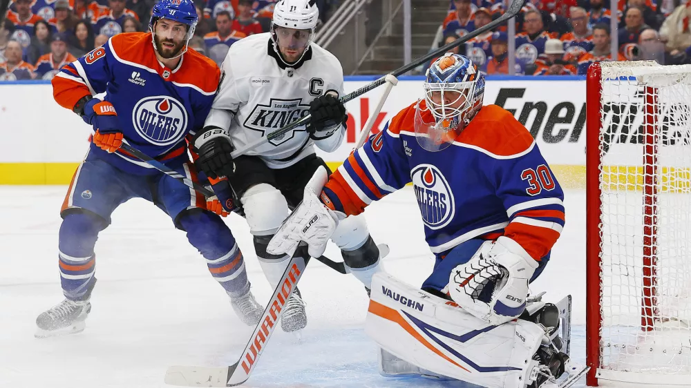 Apr 27, 2025; Edmonton, Alberta, CAN; Los Angeles Kings forward Anze Kopitar (11) battles with Edmonton Oilers forward Adam Henrique (19) in front of goaltender Calvin Pickard (30) during the second period in game four of the first round of the 2025 Stanley Cup Playoffs at Rogers Place. Mandatory Credit: Perry Nelson-Imagn Images