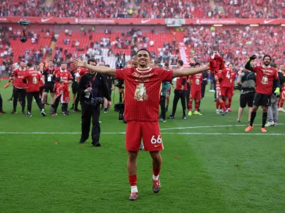 Soccer Football - Premier League - Liverpool v Tottenham Hotspur - Anfield, Liverpool, Britain - April 27, 2025 Liverpool's Trent Alexander-Arnold celebrates after winning the Premier League REUTERS/Phil Noble EDITORIAL USE ONLY. NO USE WITH UNAUTHORIZED AUDIO, VIDEO, DATA, FIXTURE LISTS, CLUB/LEAGUE LOGOS OR 'LIVE' SERVICES. ONLINE IN-MATCH USE LIMITED TO 120 IMAGES, NO VIDEO EMULATION. NO USE IN BETTING, GAMES OR SINGLE CLUB/LEAGUE/PLAYER PUBLICATIONS. PLEASE CONTACT YOUR ACCOUNT REPRESENTATIVE FOR FURTHER DETAILS..