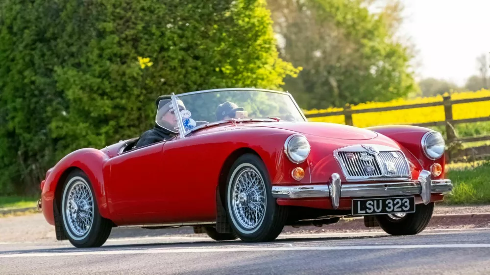 2X2D8AK Bicester,UK- Apr 21st2024: 1959 red MGA classic car driving on a British road