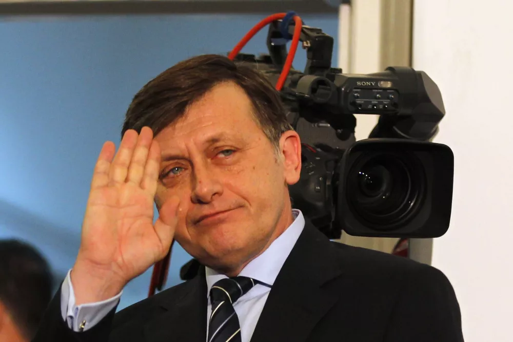 Crin Antonescu, one of Romania's Social Liberal Union (USL) leaders and president of National Liberal Party, gestures after first exit polls for parliamentary elections in Bucharest December 9, 2012. Exit polls showed Romania's prime minister won a clear victory in a Sunday election, which may herald another round of a power struggle with the rightist president and complicate talks for a new IMF deal. Victor Ponta's leftist Social Liberal Union (USL) won 54-58 percent of votes according to three exit polls and is headed for a majority, but analysts said President Traian Basescu may ask someone else from the USL to form a government. REUTERS/Bogdan Cristel (ROMANIA - Tags: POLITICS ELECTIONS)