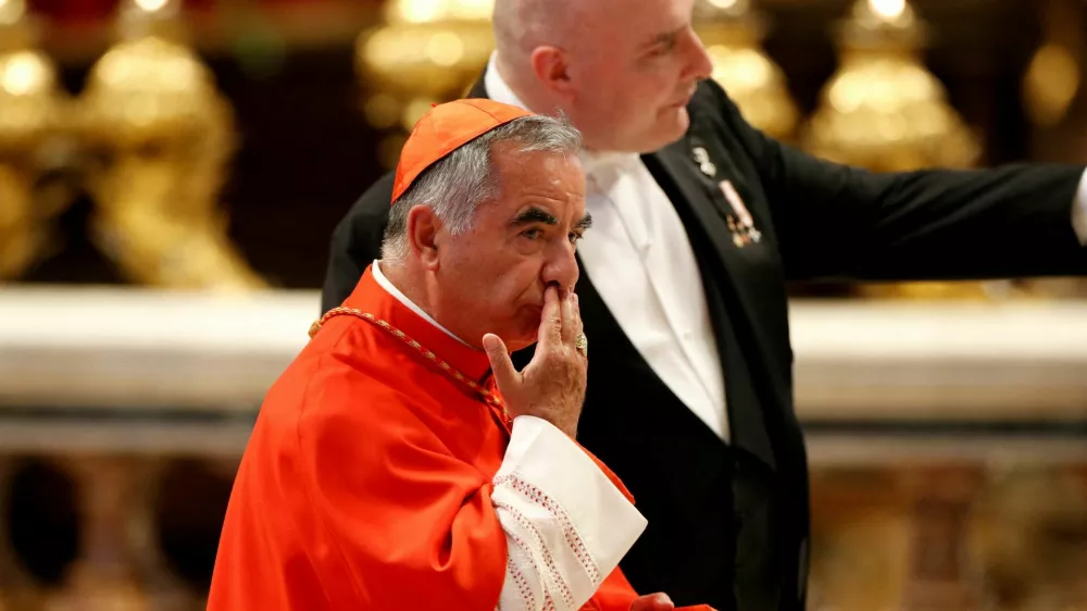 FILE PHOTO: Cardinal Angelo Becciu arrives at a consistory ceremony to elevate Roman Catholic prelates to the rank of cardinal, at Saint Peter's Basilica at the Vatican, August 27, 2022. REUTERS/Remo Casilli/File Photo