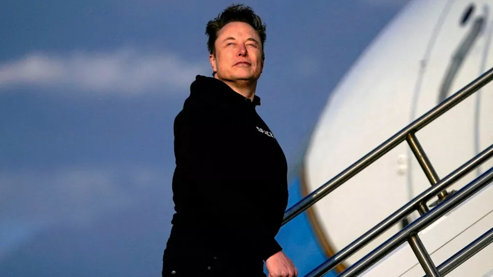 Tesla CEO Elon Musk boards Air Force One with U.S. President Donald Trump (not pictured) as they depart for Philadelphia, Pennsylvania, from Morristown Municipal Airport in Morristown, New Jersey, U.S., March 22, 2025. REUTERS/Nathan Howard