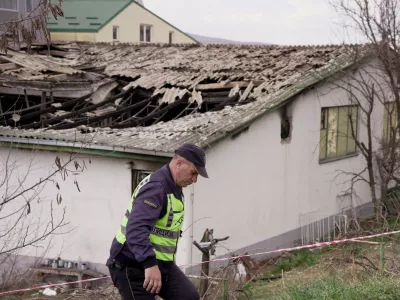 A police officer walks next to the damaged Pulse nightclub, following a fire that resulted in dozens of deaths in the town of Kocani, North Macedonia, March 17, 2025. REUTERS/Fedja Grulovic