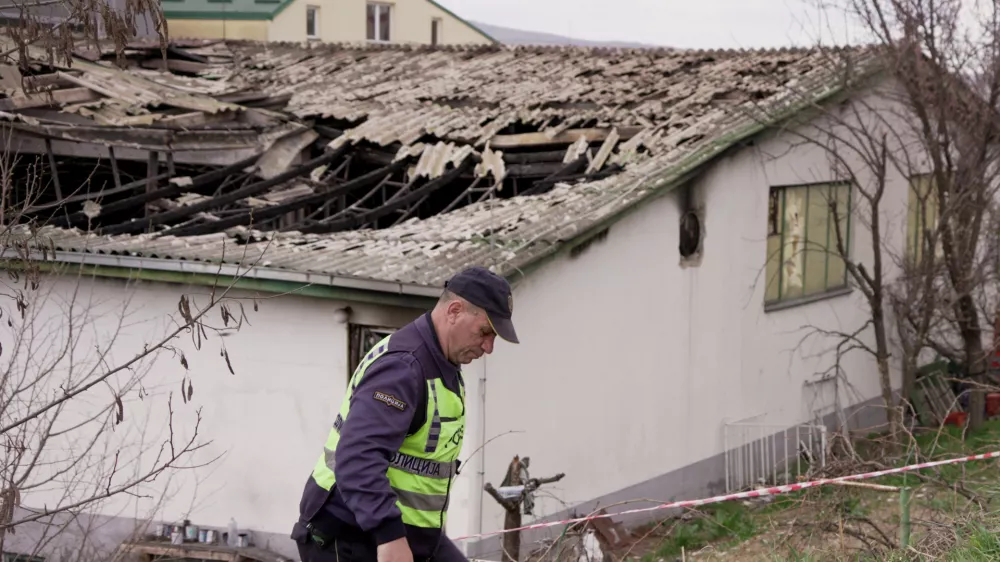 A police officer walks next to the damaged Pulse nightclub, following a fire that resulted in dozens of deaths in the town of Kocani, North Macedonia, March 17, 2025. REUTERS/Fedja Grulovic
