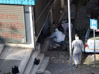 Forensics officers investigate the area of a blast caused by an explosive device outside a bank that killed a 38-year old woman, in Thessaloniki, Greece, May 3, 2025. REUTERS/Alexandros Avramidis