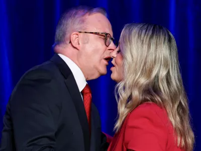 Australia's Prime Minister Anthony Albanese kisses his partner Jodie Haydon at a Labor party election night event, after local media projected the Labor Party's victory, on the day of the Australian federal election, in Sydney, Australia, May 3, 2025. REUTERS/Hollie Adams