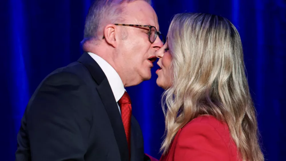 Australia's Prime Minister Anthony Albanese kisses his partner Jodie Haydon at a Labor party election night event, after local media projected the Labor Party's victory, on the day of the Australian federal election, in Sydney, Australia, May 3, 2025. REUTERS/Hollie Adams