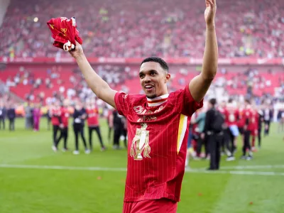 FILED - 27 April 2025, United Kingdom, Liverpool: Liverpool's Trent Alexander-Arnold celebrates victory and the Premier League title following the English Premier League soccer match between Liverpool and Tottenham Hotspur at Anfield. Arnold has announced he will leave Liverpool when his contract expires at the end of the season. Photo: Peter Byrne/PA Wire/dpa
