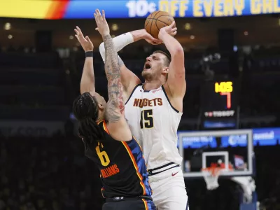 Denver Nuggets' Nikola Jokic (15) is fouled taking a shot by Oklahoma City Thunder's Jaylin Williams (6) in the first half of Game 1 of an NBA basketball second-round playoff series Monday, May 5, 2025, in Oklahoma City. (AP Photo/Nate Billings)