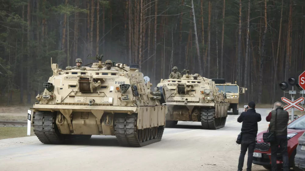 U.S. Army military vehicles including two M88 Recovery vehicles roll to attend recovery efforts continue for a missed U.S. Army soldier, as three other found dead on Monday, at a training range in Pabrade, north of Vilnius, Lithuania, Tuesday, April 1, 2025. (AP Photo/Mindaugas Kulbis)