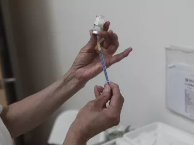 A health worker prepares a dose of the measles vaccine at the health center in Ciudad Juarez, Chihuahua state, Mexico, Wednesday, April 30, 2025. (AP Photo/Christian Chavez)