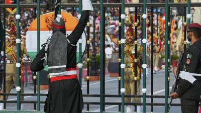 Pakistan's Rangers soldier, in black, and Indian Border Security Forces soldier, gesture to each other during a daily closing ceremony at the Wagah, a joint post on the Pakistan and India border, near Lahore, Pakistan, Saturday, May 3, 2025. (AP Photo/K.M. Chaudary)