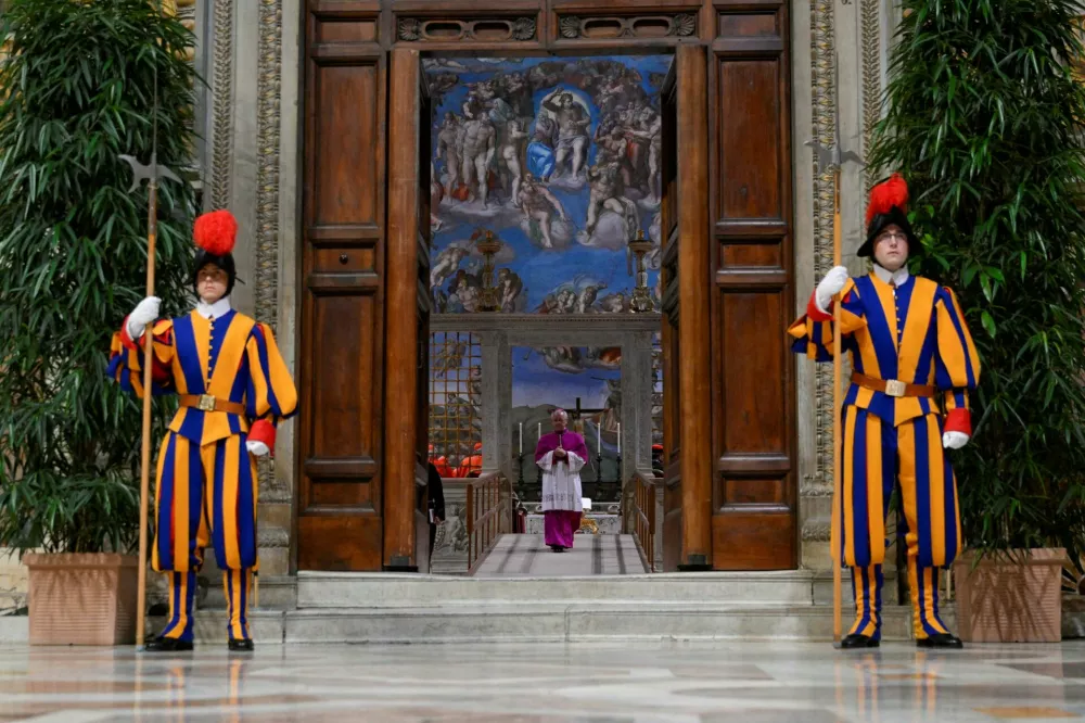 Swiss guards stand at the Sistine Chapel, ahead of the conclave to elect the next pope at the Vatican, May 7, 2025. Vatican Media/Handout via REUTERS  THIS IMAGE HAS BEEN SUPPLIED BY A THIRD PARTY