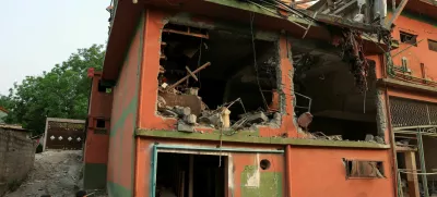 Police officers look on as a cameraman films the Bilal Mosque, after it was hit by an Indian strike in Muzaffarabad, the capital of Pakistan-administered Kashmir, May 7, 2025. REUTERS/Akhtar Soomro