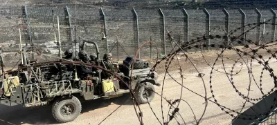 Israeli soldiers ride in a military vehicle along the ceasefire line with Syria and the Israeli-occupied Golan Heights, as seen from the Golan Heights, December 15, 2024. REUTERS/Avi Ohayon