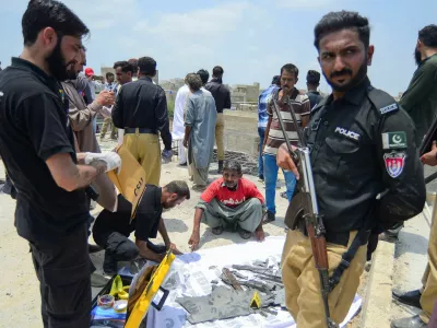 A member of the Crime Scene Unit (CSU) inspects the fragments, of what they say is a drone, after it was brought down, on the outskirts of Karachi, Pakistan May 8, 2025. REUTERS/Imran Ali