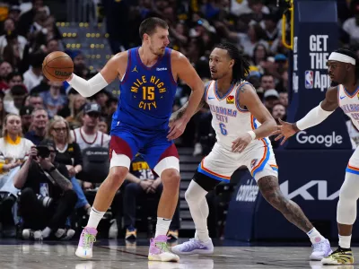 May 9, 2025; Denver, Colorado, USA; Oklahoma City Thunder forward Jaylin Williams (6) defends on Denver Nuggets center Nikola Jokic (15) in the first half during game three of the second round for the 2025 NBA Playoffs at Ball Arena. Mandatory Credit: Ron Chenoy-Imagn Images