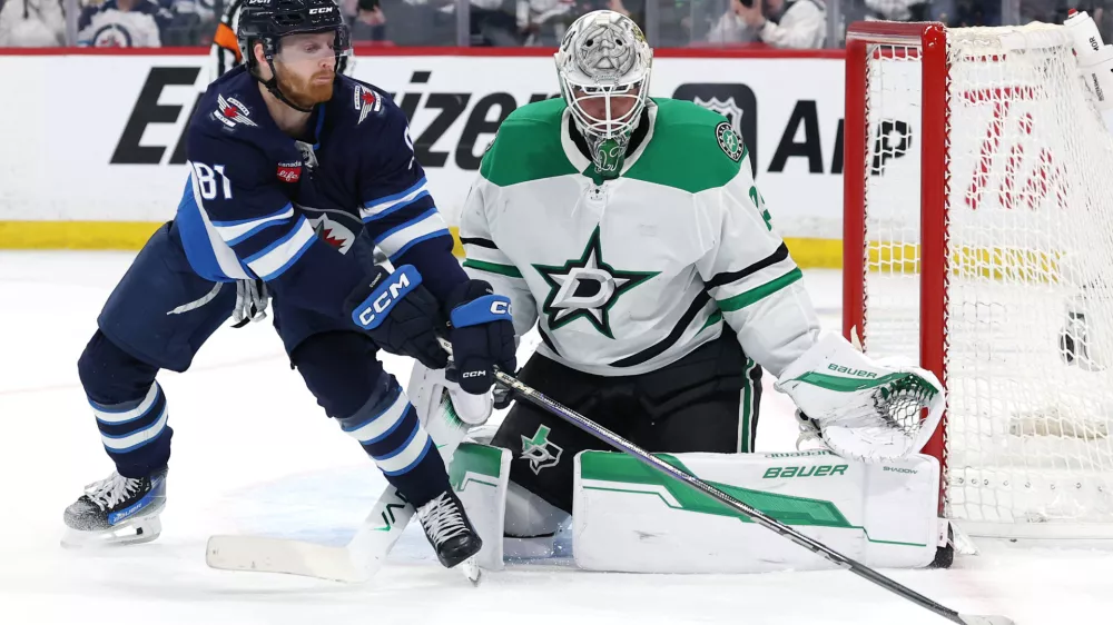 May 9, 2025; Winnipeg, Manitoba, CAN; Winnipeg Jets left wing Kyle Connor (81) stretches for the puck in front of Dallas Stars goaltender Jake Oettinger (29) in the second period in game two of the second round of the 2025 Stanley Cup Playoffs at Canada Life Centre. Mandatory Credit: James Carey Lauder-Imagn Images