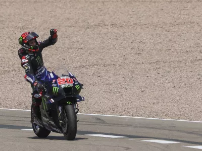 19 June 2022, Saxony, Hohenstein-Ernstthal: French rider Fabio Quartararo of the Monster Energy Yamaha MotoGP Team celebrates winning the MotoGP of Germany at the Sachsenring racing track. Photo: Jan Woitas/dpa