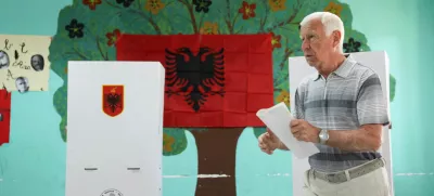 A man walks at a polling station during parliamentary election in Tirana, Albania, May 11, 2025. REUTERS/Florion Goga