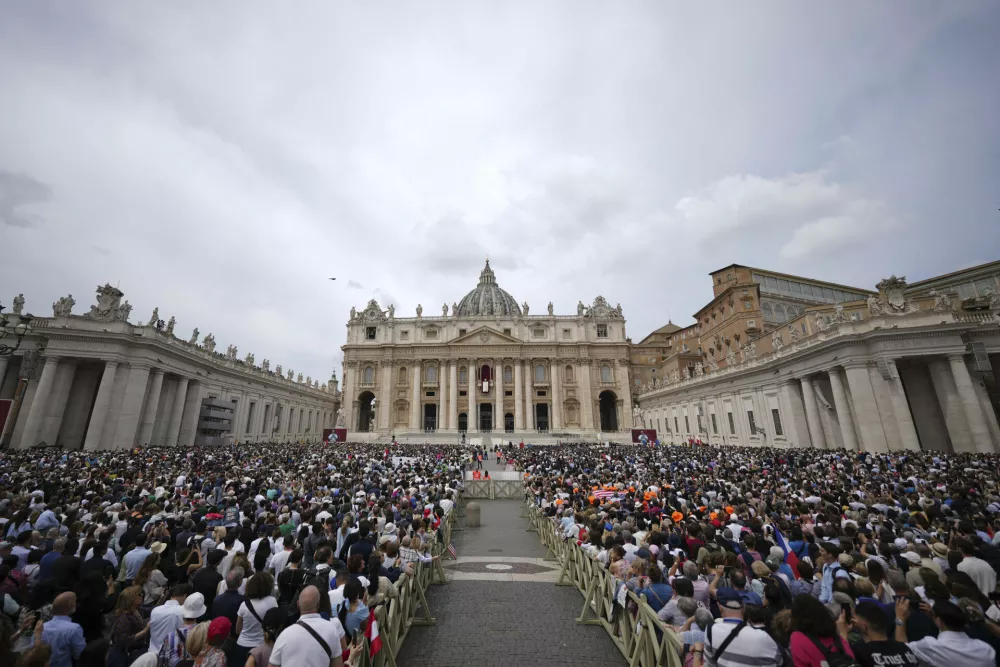 Faithful and well-wishers crowd St. Peter's Square as Pope Leo XIV appears at the central balcony of St. Peter's Basilica for his first Sunday blessing after his election, at the Vatican, Sunday, May 11, 2025.(AP Photo/Andrew Medichini)