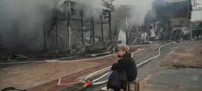 FILE PHOTO: A vendor sits at the site of the Barabashovo market hit by Russian drone strike, amid Russia's attack on Ukraine, in Kharkiv, Ukraine May 6, 2025. REUTERS/Viktoriia Yakymenko/File Photo