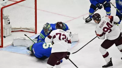 Latvia's Kristians Rubins, right, scores at Slovenia's goalkeeper Lukas Horak during the IIHF Ice Hockey World Championship group A match between Slovenia and Latvia at Avicii Arena in Stockholm, Sweden, Tuesday May 13, 2025. (Anders Wiklund/TT News Agency via AP)