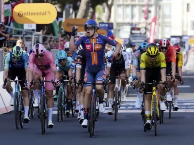 Netherlands' Casper van Uden celebrates as he crosses the finish line to win the fourth stage of the Giro d'Italia cycling race, from Alberobello to Lecce, southern Italy, Tuesday, May 13, 2025. (Gian Mattia D'Alberto/LaPresse via AP)