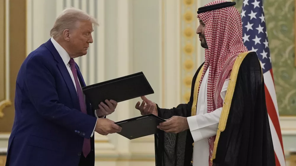 President Donald Trump and Saudi Crown Prince Mohammed bin Salman exchange documents during a signing ceremony at the Royal Palace, Tuesday, May 13, 2025. (AP Photo/Alex Brandon)