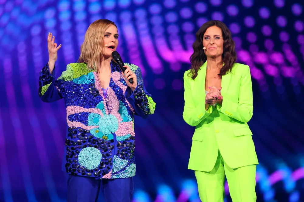 Hosts Sandra Studer and Hazel Brugger stand on stage as they wait for the start of the first semi-final of the 2025 Eurovision Song Contest, in Basel, Switzerland, May 13, 2025. REUTERS/Denis Balibouse