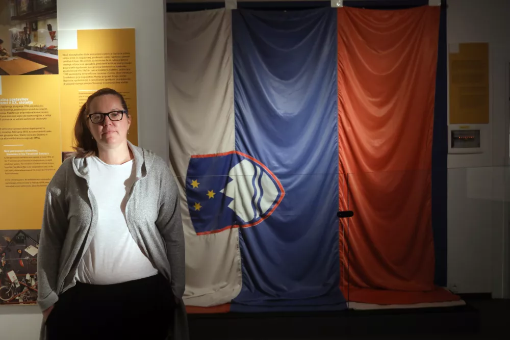 kustosinja Nata&scaron;a Strlič- slovenska zastava katera je slovesno zaplapolala 26. junija 1991 na večerni slovesnosti razglasitve samostojnosti na Trgu republike v Ljubljani- 17.09.2018 - Muzej novej&scaron;e zgodovine Slovenije -//FOTO: Jaka Gasar / Foto:: Jaka Gasar