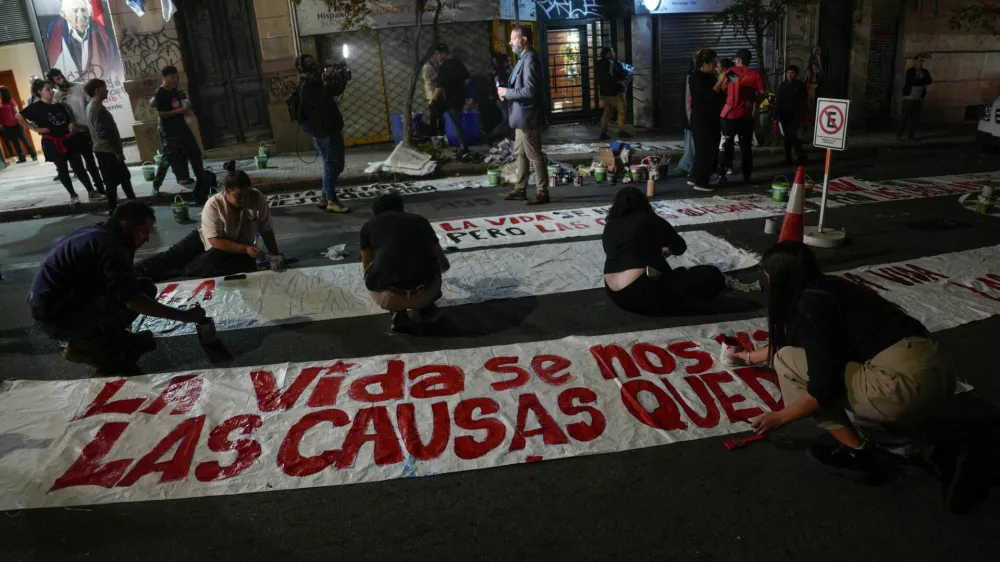 People paint banners outside the Movimiento de Participacion Popular (MPP) party headquarters, following the death of Uruguay's former President Jose "Pepe" Mujica at the age of 89, in Montevideo, Uruguay May 13, 2025. REUTERS/Andres Cuenca