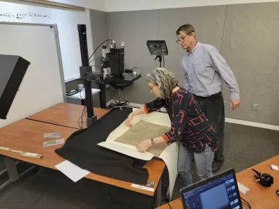 This photo provided by R.B. Toth Associates shows researchers using imaging technology on a copy of the Magna Carta from 1300 to reveal details that are not visible to the human eye on March 19, 2024, at the Weissman Preservation Center at Harvard University in Cambridge, Mass. (R.B. Toth Associates via AP)