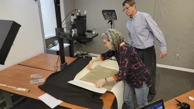 This photo provided by R.B. Toth Associates shows researchers using imaging technology on a copy of the Magna Carta from 1300 to reveal details that are not visible to the human eye on March 19, 2024, at the Weissman Preservation Center at Harvard University in Cambridge, Mass. (R.B. Toth Associates via AP)