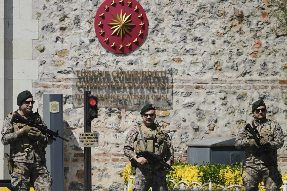 Turkish security members stand guard at Dolmabahce palace where talks between Russian and Ukrainian delegations are expected, in Istanbul, Turkey, Thursday, May 15, 2025. (AP Photo/Dilara Acikgoz)