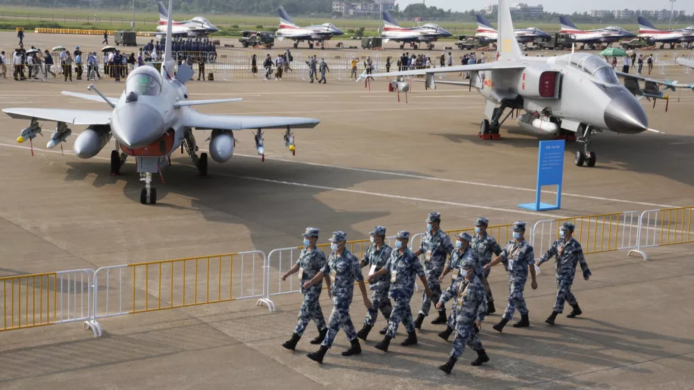 Chinese Air Force personnel march past the Chinese military's J10C fighter and JH-7A2 fighter bomber during 13th China International Aviation and Aerospace Exhibition, also known as Airshow China 2021, Wednesday, Sept. 29, 2021, in Zhuhai in southern China's Guangdong province. With record numbers of military flights near Taiwan over the last week, China has been stepping up its harassment of the island it claims as its own, showing an new intensity and sophistication as it asserts its territorial claims in the region. (AP Photo/Ng Han Guan)