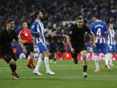 Barcelona's Fermin Lopez, right, celebrates with his teammate Barcelona's Gavi after scoring his side's second goal during a Spanish La Liga soccer match between Barcelona and Espanyol at Lluis Companys Olympic Stadium in Barcelona, Spain, Thursday, May 15, 2025. (AP Photo/Joan Monfort)