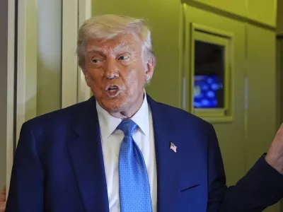 President Donald Trump speaks on Air Force One at Abu Dhabi International Airport before departing, Friday, May 16, 2025, in Abu Dhabi, United Arab Emirates. (AP Photo/Alex Brandon)