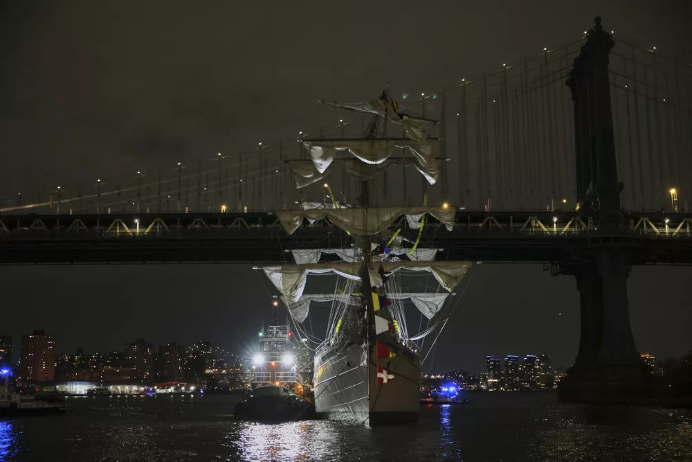 A tug boat helps stabilize the Cuauht&eacute;moc, a masted Mexican Navy training ship as it sits stranded near the Manhattan Bridge after colliding with the Brooklyn Bridge, Saturday, May 17, 2025, in New York. (AP Photo/Yuki Iwamura)
