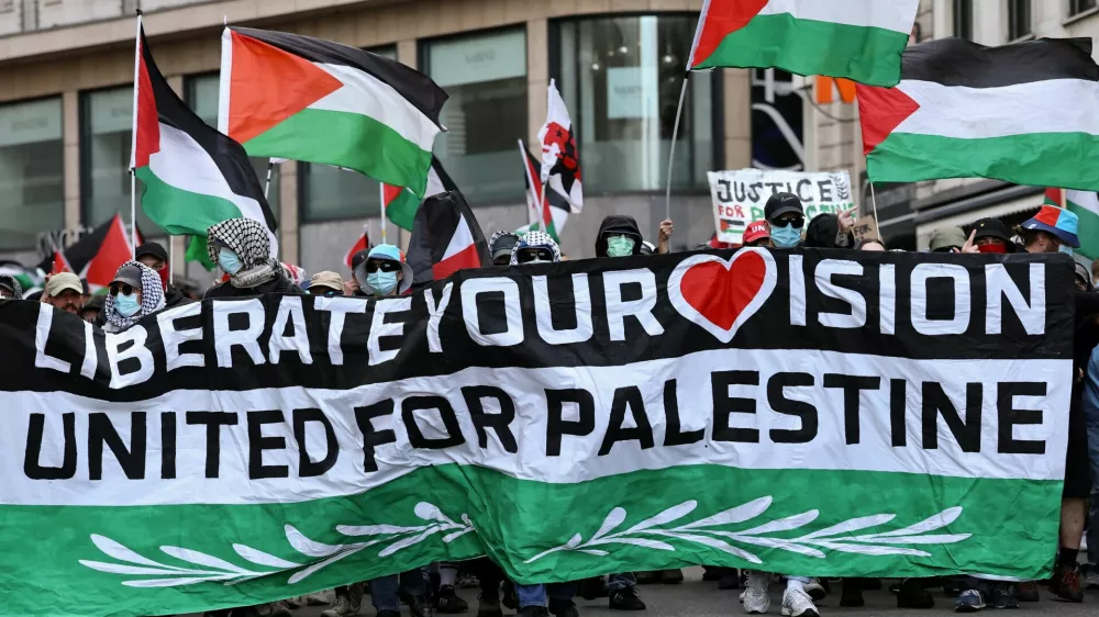 Pro-Palestinian demonstrators hold flags during a protest, on the day of the Grand Final of the 2025 Eurovision Song Contest in Basel, Switzerland, May 17, 2025. REUTERS/Christian Hartmann