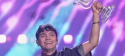 Winner of the Eurovision Song Contest JJ from Austria holds up the trophy onstage, he won with the song "Wasted Love" during the Grand Final of the 69th Eurovision Song Contest, in Basel, Switzerland, early Sunday, May 18, 2025. (AP Photo/Martin Meissner)