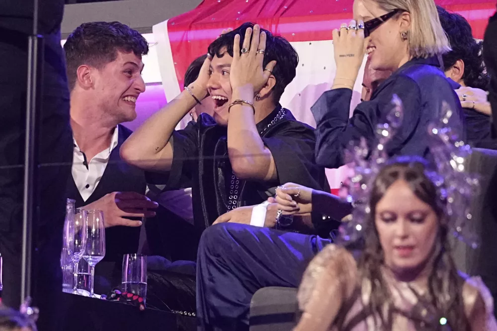 JJ from Austria who performed the song "Wasted Love" reacts to voting during the Grand Final of the 69th Eurovision Song Contest, in Basel, Switzerland, early Sunday, May 18, 2025. (AP Photo/Martin Meissner)