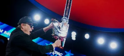 Elon Musk holds up a chainsaw onstage during the Conservative Political Action Conference (CPAC) in National Harbor, Maryland, U.S., February 20, 2025. REUTERS/Nathan Howard  TPX IMAGES OF THE DAY