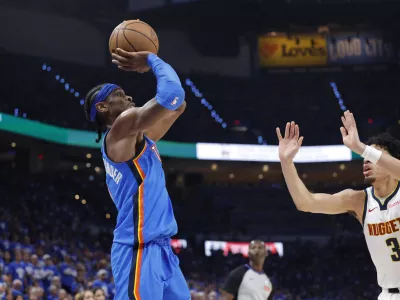 May 18, 2025; Oklahoma City, Oklahoma, USA; Oklahoma City Thunder guard Shai Gilgeous-Alexander (2) shoots as Denver Nuggets guard Julian Strawther (3) defends in the second half of game seven of the second round for the 2025 NBA Playoffs at Paycom Center. Mandatory Credit: Alonzo Adams-Imagn Images