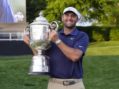 May 18, 2025; Charlotte, North Carolina, USA; Scottie Scheffler poses for a photo with the Wanamaker Trophy after winning the PGA Championship golf tournament at Quail Hollow. Mandatory Credit: Jim Dedmon-Imagn Images