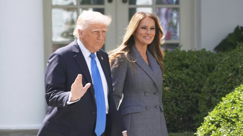 President Donald Trump and first lady Melania Trump arrive in the Rose Garden at the White House, Monday, May 19, 2025 in Washington, where President Trump will sign the "Take It Down Act". (AP Photo/Manuel Balce Ceneta)