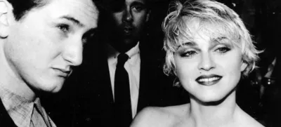 Sean Penn and his wife, singer Madonna, stop April 17, 1986 to chat with reporters prior to the screening of Penn's new movie "At Close Range" in Los Angeles. (AP photo/Craig Mathew)
